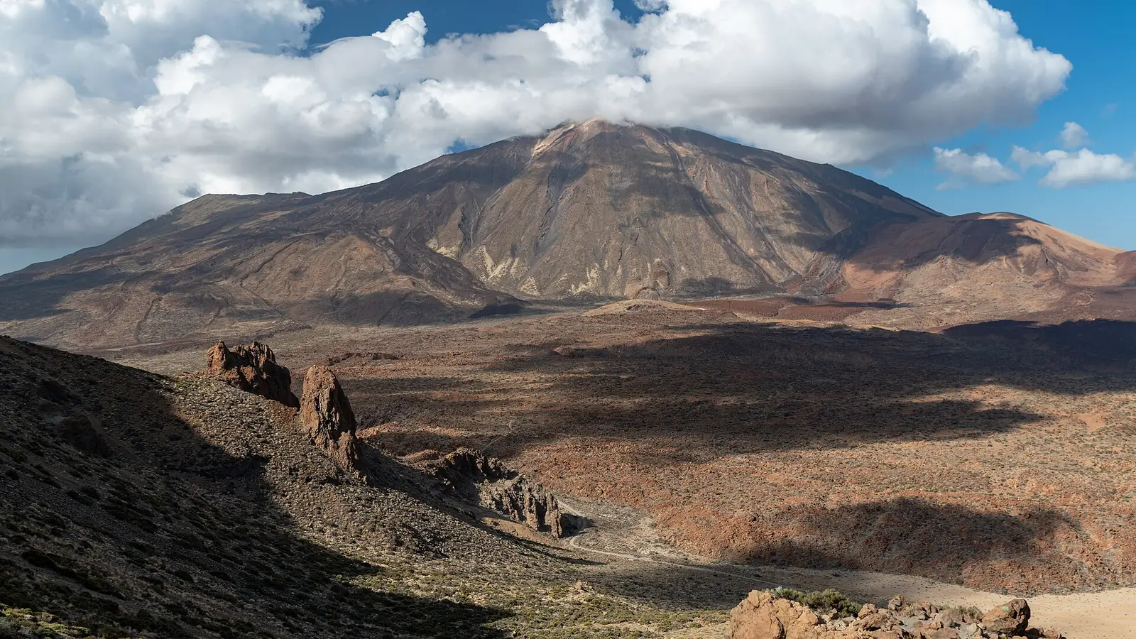 Mount Teide above the volcanic plains and rock formations of Teide National Park